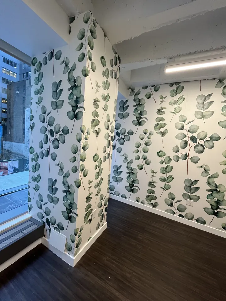 Faux foliage green wall preparation during the salon transformation