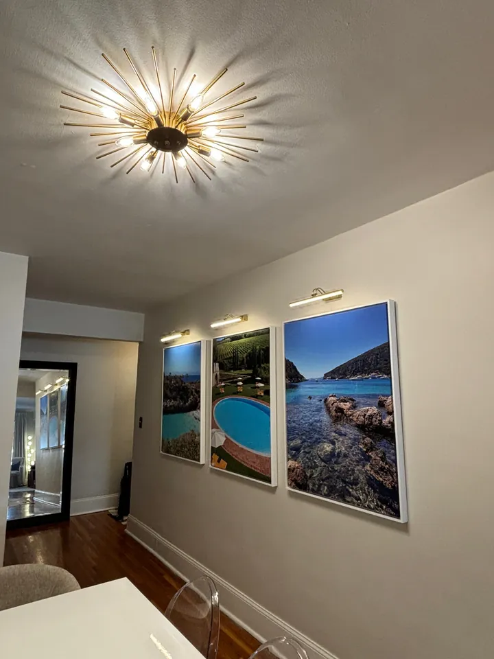 Hallway with precisely mounted framed artwork
