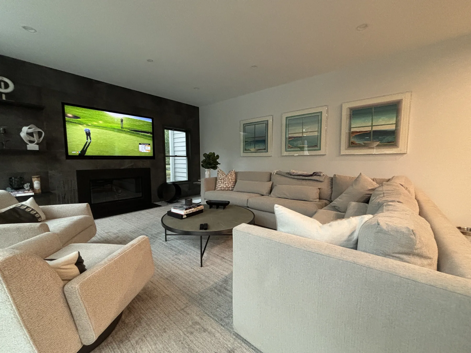 Completed modern living room outfitting with sectional sofa and framed art in Harrison NY