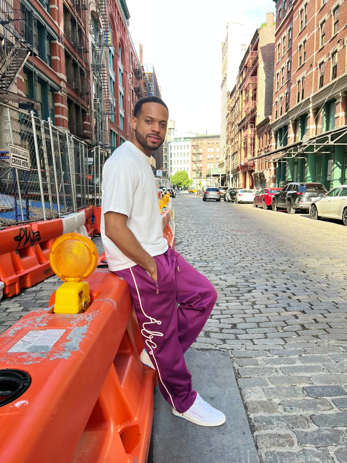 Julian Boyce, founder of Flat Arq LLC, photographed on a cobblestone street in New York City