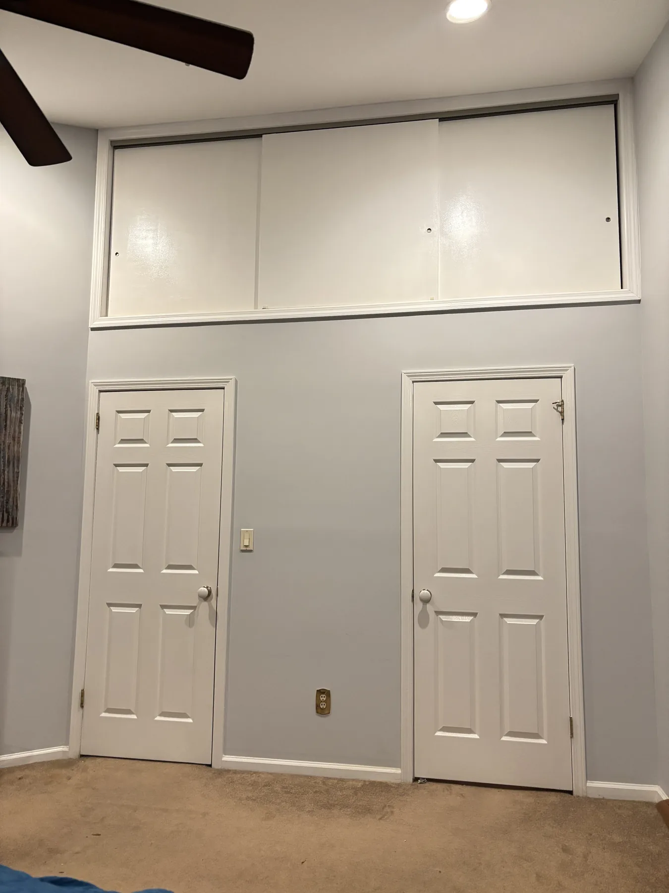 Completed loft cavity enclosure with painted sliding doors