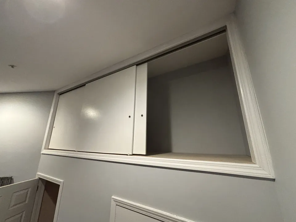 Detail of the painted sliding doors with finger-handle notches