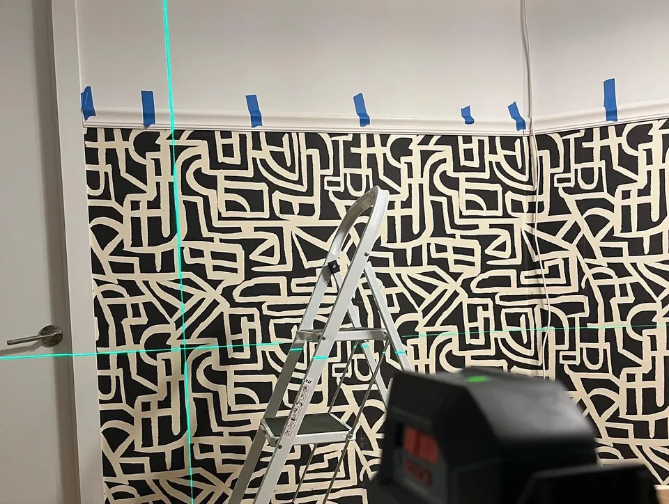 Detail of the tribal monogram wallpaper panel between trim