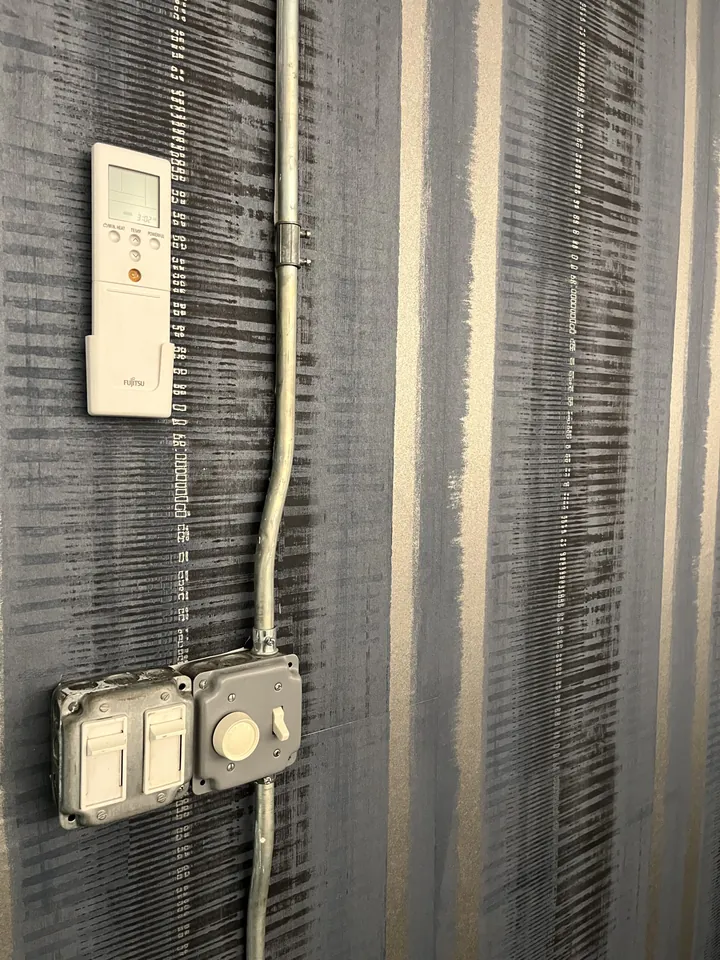 Detail of maze pattern wallpaper around electrical fixtures at Mosaic NYC