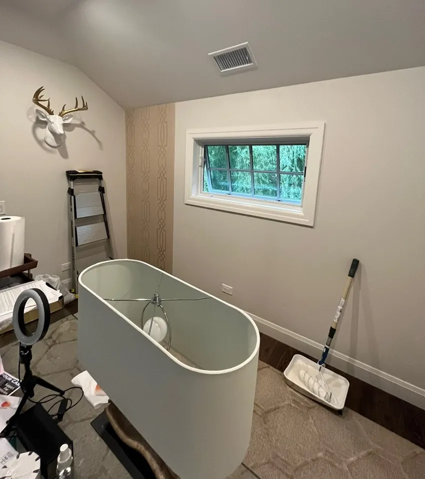 Bathroom refresh in progress with freestanding tub and ladder