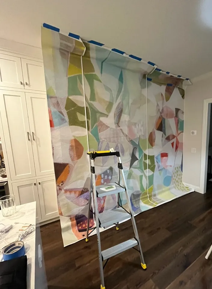 AREA Environments abstract wallpaper being installed around the kitchen doorway