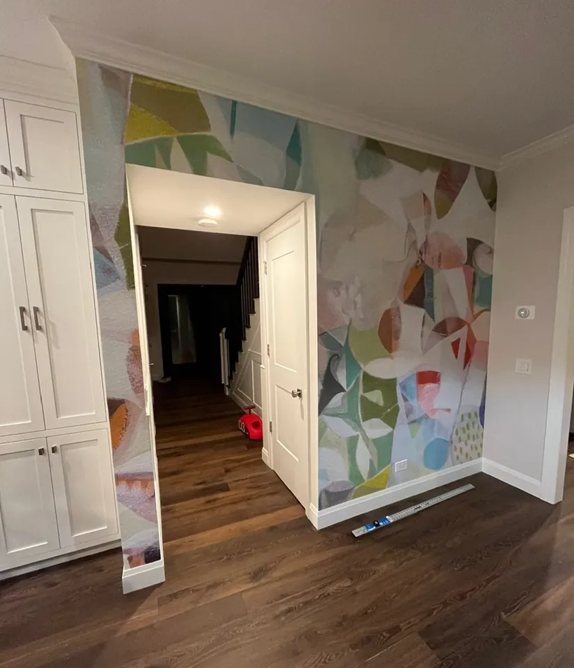 Finished kitchen pass-through column wrapped in abstract art wallpaper