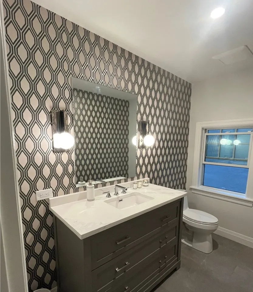Powder room vanity against diamond metallic wallpaper applied by Flat Arq