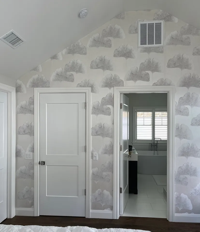 Cloud wallpaper accent wall framing the doorway to the en suite bathroom
