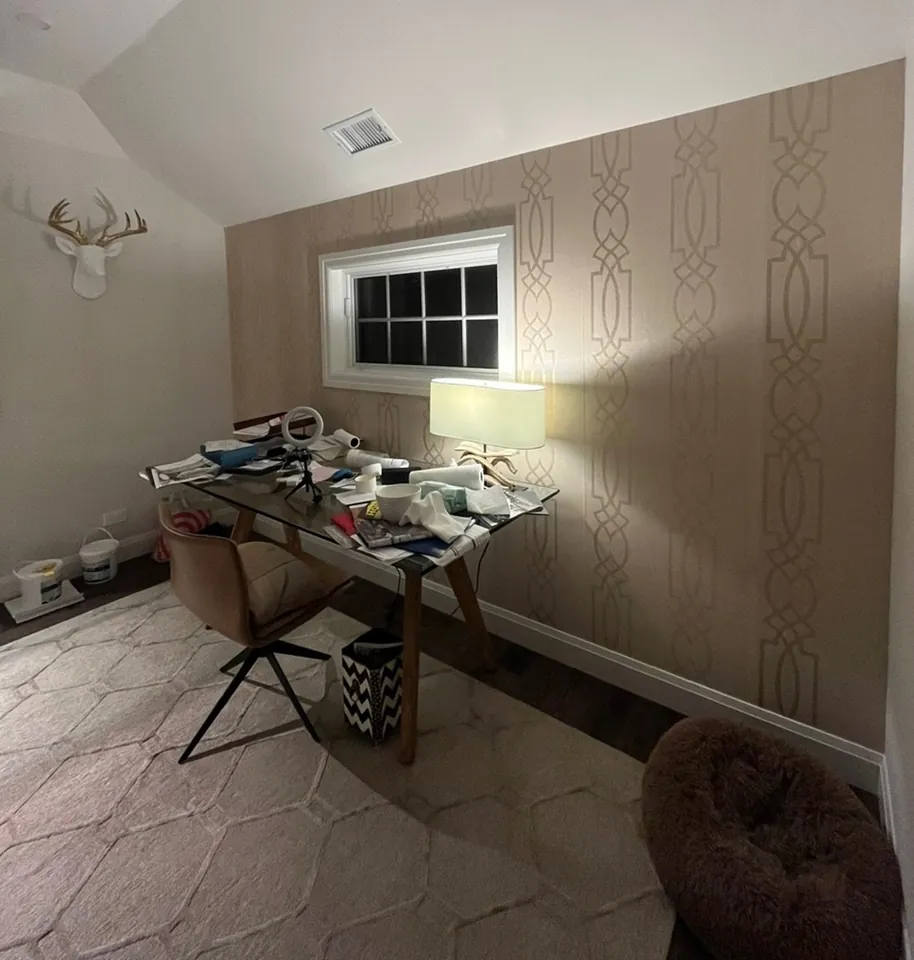 Work study with trellis pattern wallpaper accent wall